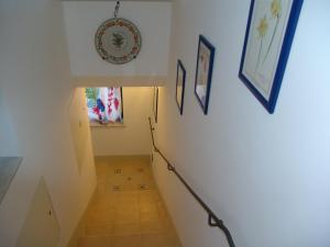 a staircase in a house with a plate on the wall at Il Cavaliere in Noto