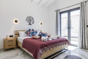 a bedroom with a bed with two stuffed animals on it at Ioanna House - Seaside Living, Walk to Beach in Skopelos Town
