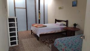 a bedroom with a bed and a table and a ladder at Arrullos del Mar in Zorritos +7 photos