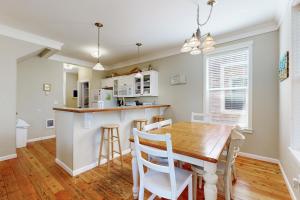 a kitchen and dining room with a wooden table and chairs at Bella Beach Home in Depoe Bay