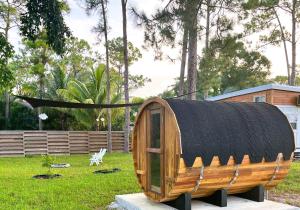 a small wooden boat on display in a yard at Summer Tiny House in West Palm Beach