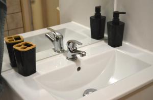 a bathroom sink with two soap dispensers on it at Oasis Verte in La Calamine +17 photos