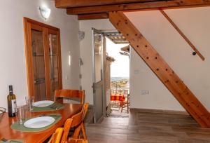 a dining room with a table and chairs and a staircase at Evanthia's mansion in Limbókhova