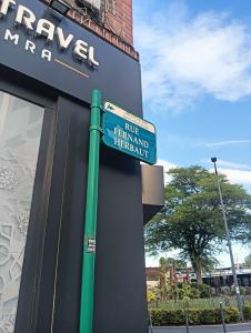 a street sign on the side of a building at 12 RUE FERNAND HE93600 Aulnay SOUS BOIS in Aulnay-sous-Bois
