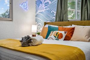 a bedroom with a bed with a stuffed animal on it at Surfari Pompano! Heated Pool Home 9 Mins To Beach in Pompano Beach