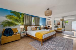 a bedroom with a king sized bed and a couch at Surfari Pompano! Heated Pool Home 9 mins to Beach in Pompano Beach