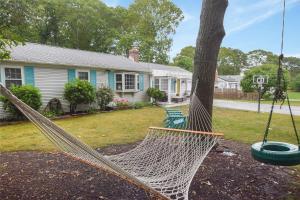 a hammock hanging from a tree in a yard at Sunroom Central A C Large Fenced Yard in Yarmouth
