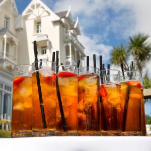 a row of glasses of iced tea on a table at Somerville Hotel in Saint Aubin