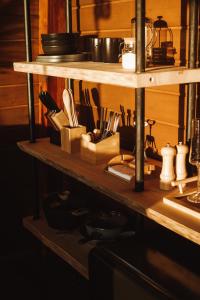 a kitchen shelf with knives and utensils on it at Vale Aurora Cabanas in Tijucas