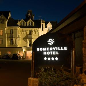a sign for a hotel in front of a building at Somerville Hotel in Saint Aubin