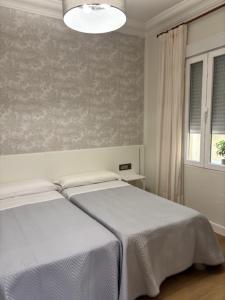 Łóżko lub łóżka w pokoju w obiekcie Pensión Numancia