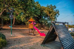 a playground with a slide and a swing set at Sea Point in Celle Ligure