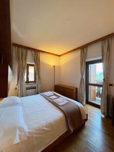 Postelja oz. postelje v sobi nastanitve Neider Hotel - Alpine Retreat Sauris