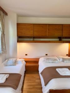 Postelja oz. postelje v sobi nastanitve Neider Hotel - Alpine Retreat Sauris