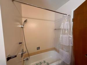 a bathroom with a bath tub with a shower curtain at Great Stay in South San Jose in San Jose +86 photos