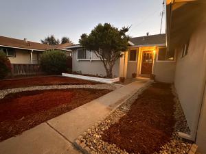 a house with a yard with a tree in front of it at Great Stay in South San Jose in San Jose