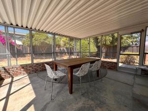 a patio with a wooden table and chairs at Great Stay in South San Jose in San Jose