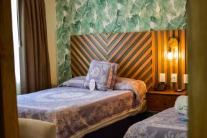 Postel nebo postele na pokoji v ubytování Hotel Isabel