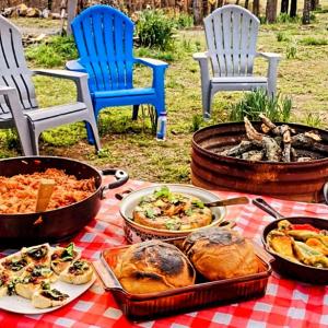 a table with many different dishes of food on it at Bigfoot Hideout in Winslow +19 photos