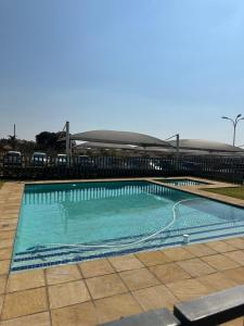 a swimming pool with blue water in front of a building at Tranquility in Carlswald in Midrand