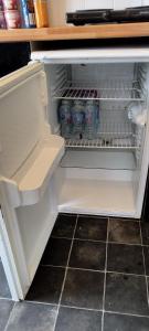 an open refrigerator with drinks and soda in it at Horncastle Golf Course, Room 2 in Edlington