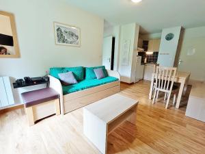 a living room with a couch and a table at La Bicyclette, T2, wifi, parking, balcon, 4 personnes in Luchon