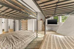 a bedroom with two beds and a flat screen tv at Iconic Vail Dome Unit 2 in Vail