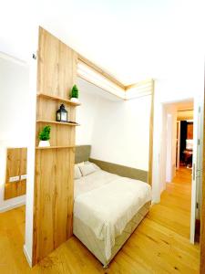 a bedroom with a bed with a wooden shelf at Oaza in Sarajevo +34 photos
