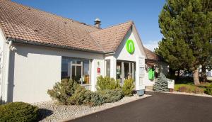 a store front of a building with a sign on it at Campanile Pontarlier in Pontarlier