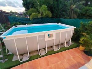 a bath tub sitting on top of a yard at Les Naïades in Goyave