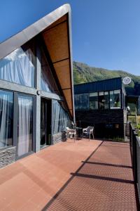 a building with a patio with a table in front of it at Kazbegi Targmani Cottages in Kazbegi +33 photos
