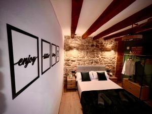 a bedroom with a bed and pictures on the wall at Ca La Minyona in Cardona