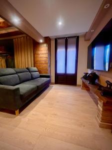 a living room with a couch and a flat screen tv at Ca La Minyona in Cardona +22 photos