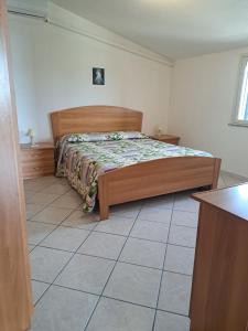a bedroom with a bed and a tiled floor at Casa Concetta in Noto Marina