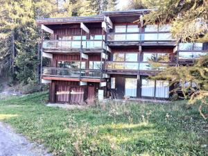 a large building with glass windows on the side of a road at Résidence Deux Tetes - Très agréable 2 pièces dans un quartier calme à 50 mètres des pistes MAE-4491 in Arc 1600