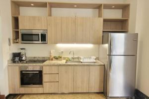 a kitchen with a stainless steel refrigerator and cabinets at Beautiful apartment in Casco Viejo, Casa Rio Apt #2 in Panama City