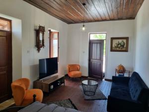 a living room with a couch and a tv at Villa Christothea in Paphos