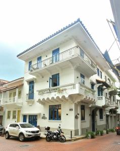 a white building with a motorcycle parked in front of it at Beautiful apartment in Casco Viejo, Casa Rio Apt #2 in Panama City