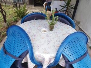 a table with blue chairs and a table with a flower table cloth at Tin in Slavonski Brod