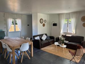a living room with a table and a couch at Cosy Villa Arcachon Bay in Audenge