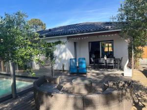 a house with a patio and a swimming pool at Cosy Villa Arcachon Bay in Audenge