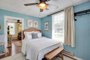 a bedroom with a bed and a ceiling fan at The Cabernet Cabin Defiance Home on Katy Trail! in Defiance