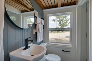 a bathroom with a sink and a window at The Chardonnay Chalet Defiance Studio Trail! in Defiance