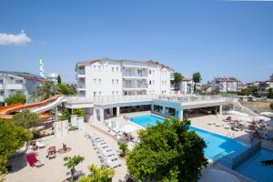 a hotel with a swimming pool and a building at Catty Cats Garden Hotel in Side