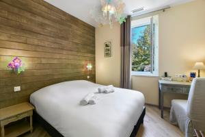Postel nebo postele na pokoji v ubytování Logis Hôtel & Restaurant Le Cadet de Gascogne