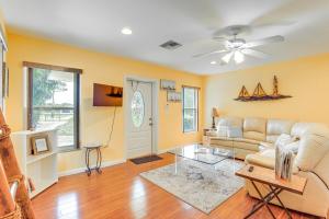 a living room with a couch and a table at Cozy Palm City Home on 5-Acre Working Farm in Palm City