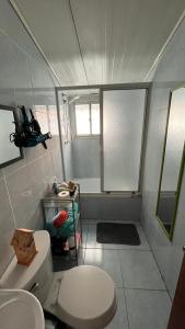 a small bathroom with a toilet and a sink at Cabaña con estacionamiento privado in Llanquihue +22 photos