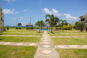 a walkway through a park with a playground at Crusoe Escape Villa in Crown Point