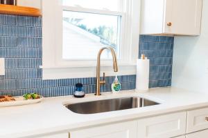 a kitchen counter with a sink and a window at NEW! 1937 Coastal Cottage by Beach, Boardwalk, & Lake! in Carolina Beach +40 photos