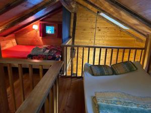 a room with a bed in a wooden cabin at Magnifique racard rénové isolé 10 minutes de marche in Haudères